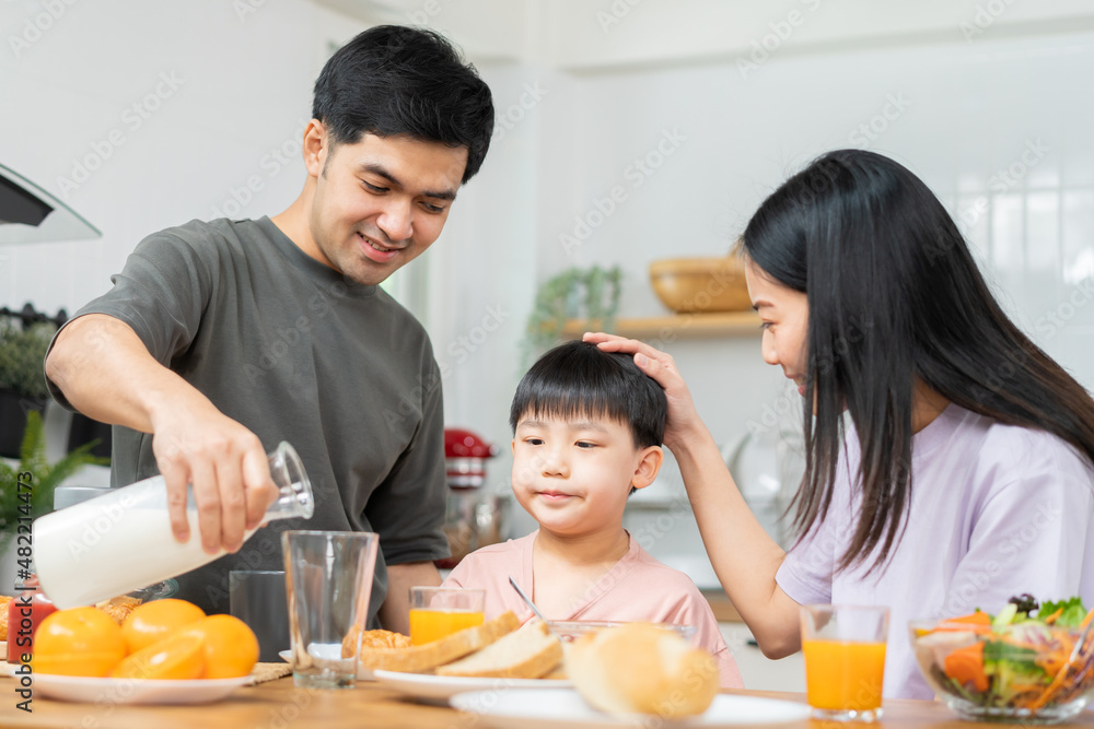 Happy refreshment family breakfast in morning, asian young parent father, mother and little cute boy, child having meal in kitchen eating together at home. Cheerful, enjoy cooking people. Happy refreshment family breakfast in morning, asian young parent father, mother and little cute boy, child having meal in kitchen eating together at home. Cheerful, enjoy cooking people.