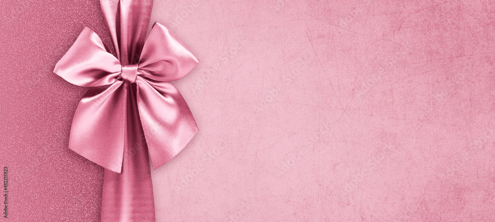 Mothers day gift card, shiny pink satin ribbon bow isolated on pink glittering background, blank template layout with copy space, top view and also for women's day or greetings card Mothers day gift card, shiny pink satin ribbon bow isolated on pink glittering background, blank template layout with copy space, top view and also for women's day or greetings card