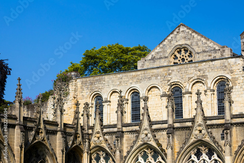 Sunlight shines on the portland stone of the buildings surrounding Canterbury Cathedral's courtyard