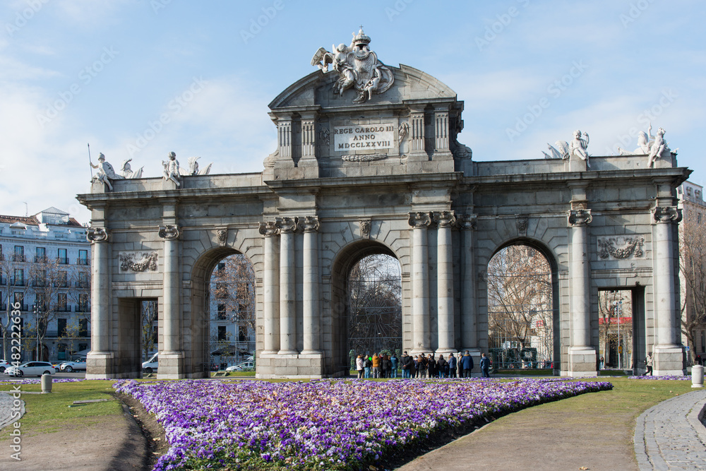 Beautiful view of Puerta de Alcala in a sunny day. Old granite entrance in Madrid, Spain