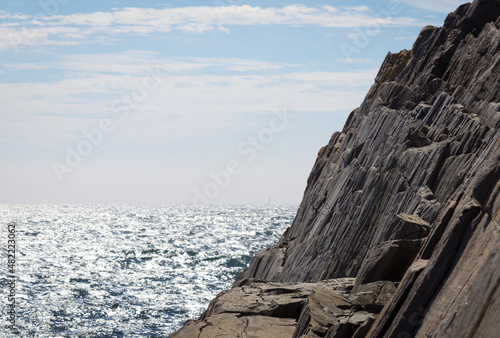 Rocks by the sea. Waves and bright sunlight, summer