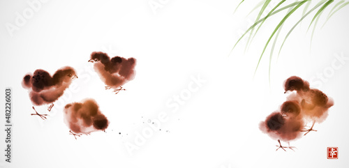 Little fluffy chicks in green grass. Traditional oriental ink painting sumi-e, u-sin, go-hua. Hieroglyph - happiness.