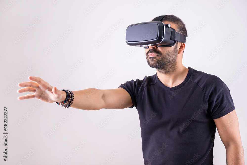 Young man in VR glasses headset gesturing portrait. Virtual reality, future technology, education video gaming Young man in VR glasses headset gesturing portrait. Virtual reality, future technology, education video gaming