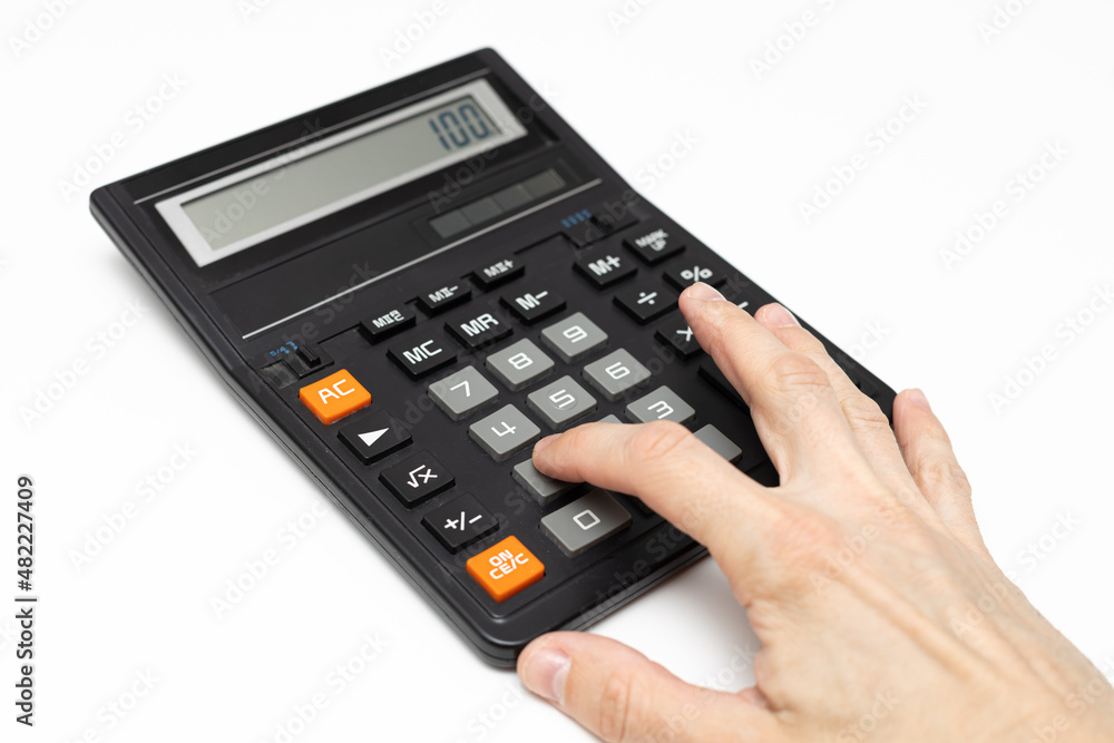 the finger of the hand presses the keys of the old calculator the finger of the hand presses the keys of the old calculator