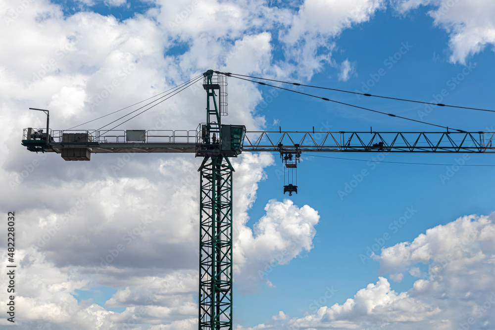 Silhouette of a high-rise construction crane against the sky Silhouette of a high-rise construction crane against the sky