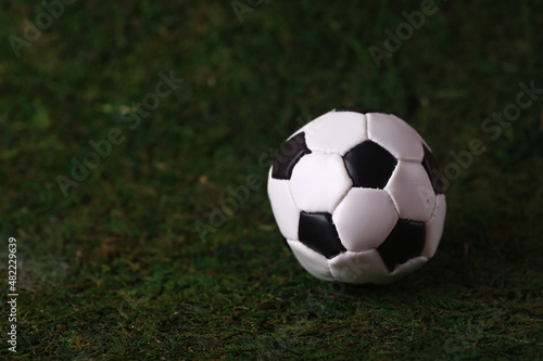soccer ball isolated on green grass background © afrumgartz