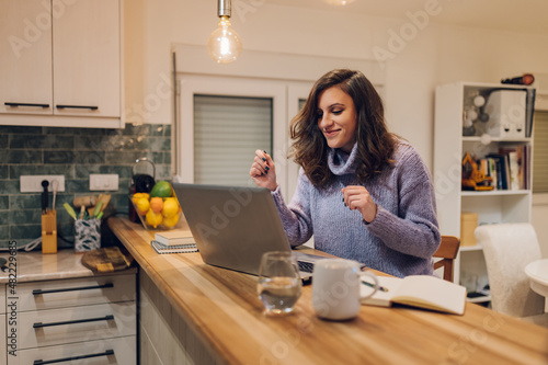 Hispanic woman using a laptop while working form home