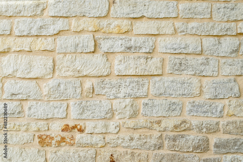 Fragment of ancient medieval fortress wall made of limestone. Vintage background. Natural old stone. Pattern in medieval style. Elements of medieval architecture. Selective focus. Fragment of ancient medieval fortress wall made of limestone. Vintage background. Natural old stone. Pattern in medieval style. Elements of medieval architecture. Selective focus.