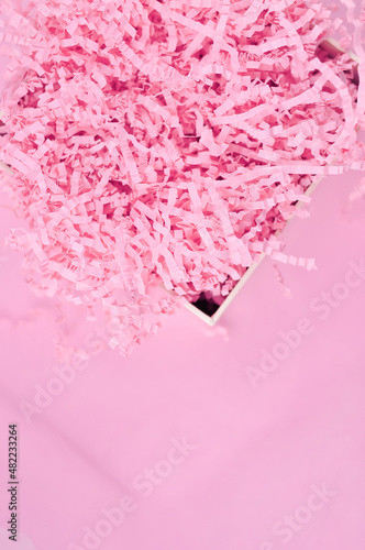 Calm pink background with tissue paper in present box photo