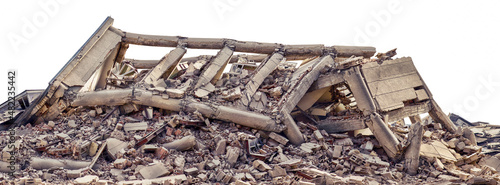 Collapsed and destroyed concrete industrial building isolated on white background. Disaster scene full of debris, dust and damaged house