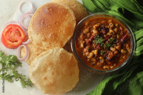 Whole wheat puris served with black eyed beans or cowpea beans gravy as side dish photo