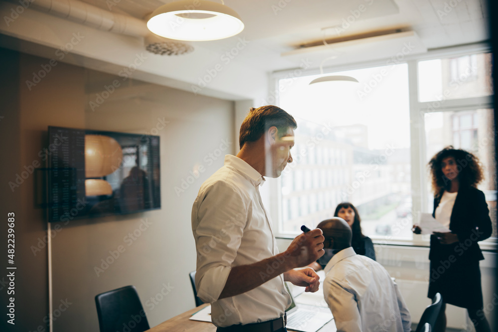 Businesspeople working in an office meeting room Businesspeople working in an office meeting room