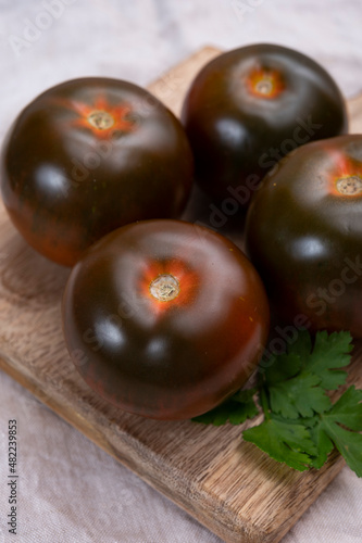 Healthy vegetarian food, reddish brown sweet kumato tomatoes photo