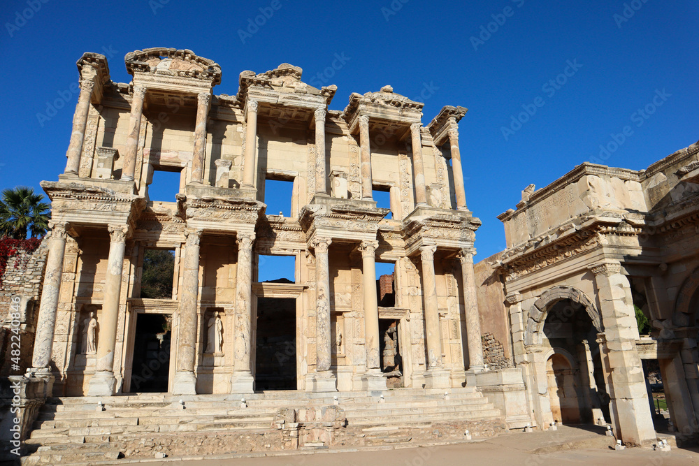 beautiful facade with columns of Library of Celsus in archaeological site Ephesus in Turkey under clear blue sky
