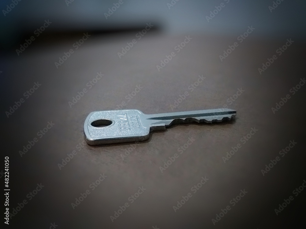 A key tucked away on the brown table A key tucked away on the brown table
