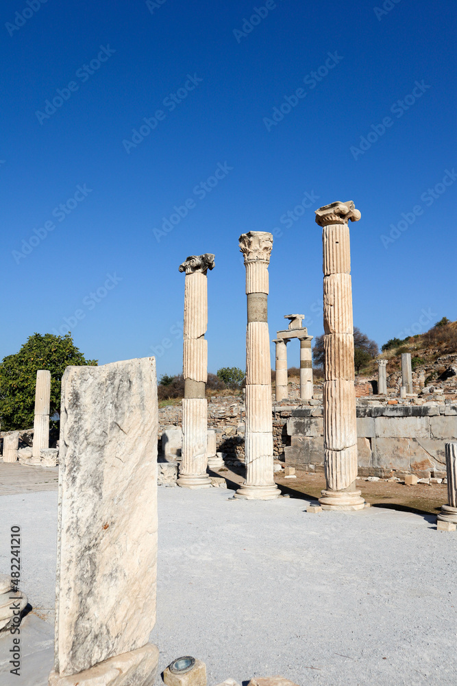 columns on the ruins of ancient city Ephesus in Turkey under blue sky