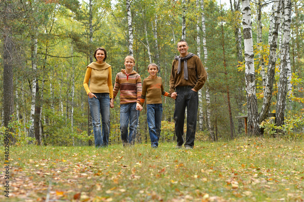 Portrait of happy young family resting in a park Portrait of happy young family resting in a park