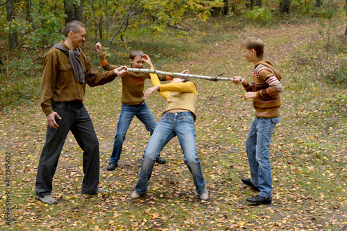 Family of four having fun in forest