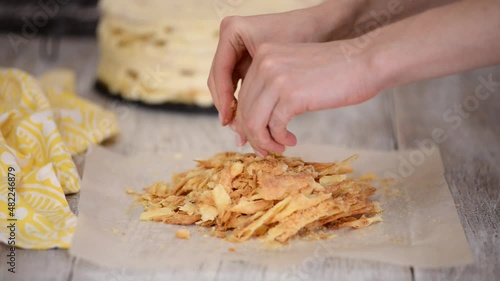 Woman hands making crumble for napoleon cake.