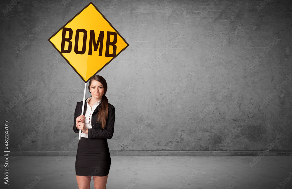 Young business person holding road sign Young business person holding road sign