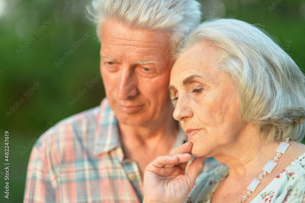 Portrait of unhappy senior couple in the park