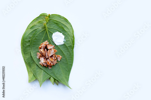 Chewing betel nut, Betel nut with cal lime powder on betel leaves