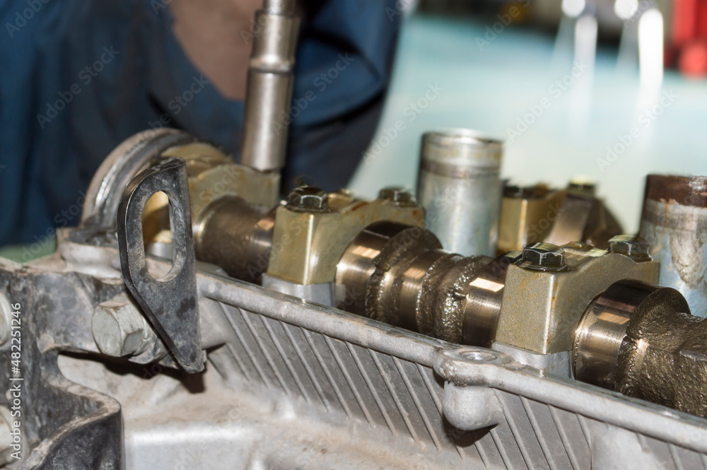 A fragment of the timing camshaft installed in the head of the engine block A fragment of the timing camshaft installed in the head of the engine block