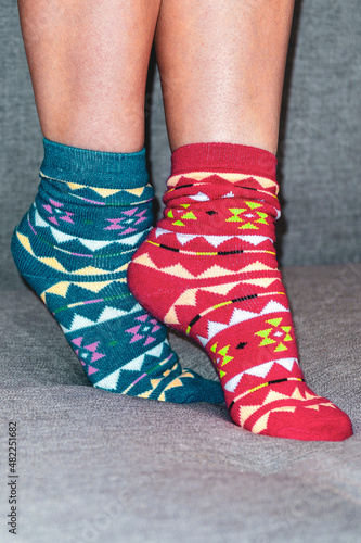  Women's legs in different beautiful socks. Colored socks on a background. Foot concept warm.Close up.