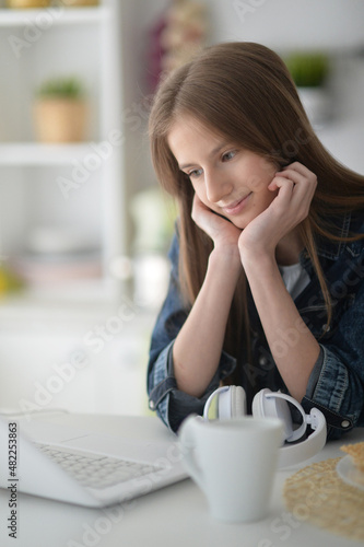 beautiful girl using laptop at home