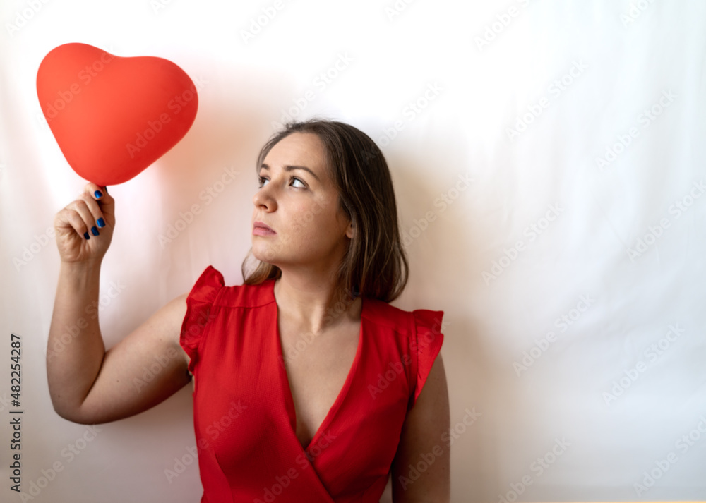 woman holding a heart shaped balloon woman holding a heart shaped balloon