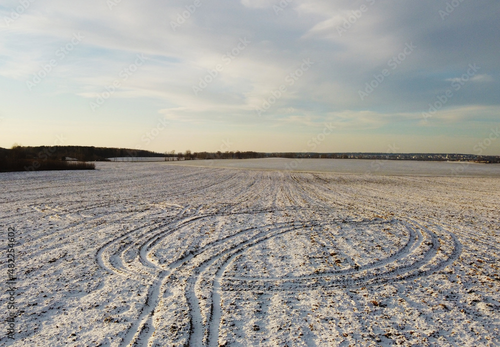 Top view photo of a winter suburban landscape with snowy fields, meadows and forests Top view photo of a winter suburban landscape with snowy fields, meadows and forests
