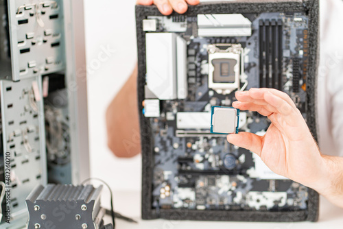 hand of repairman with a processor. professional services. 