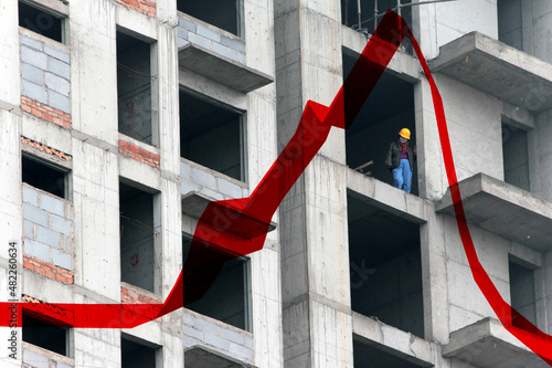 A construction worker at an appartment building site, China. The red trend-line reflects the increasing house prices. photo