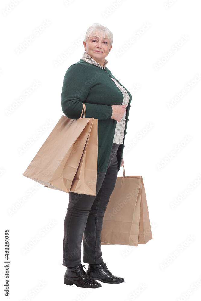 Smiling senior woman with shopping bags over white background Smiling senior woman with shopping bags over white background