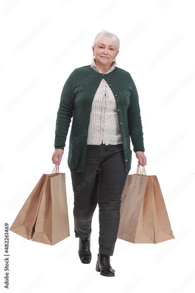 Full body senior woman cheerful and smiling, very excited carrying a shopping bags Full body senior woman cheerful and smiling, very excited carrying a shopping bags