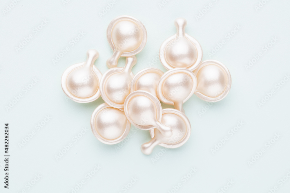 Hyaluronic acid capsule on pastel background. Hyaluronic acid capsule on pastel background.