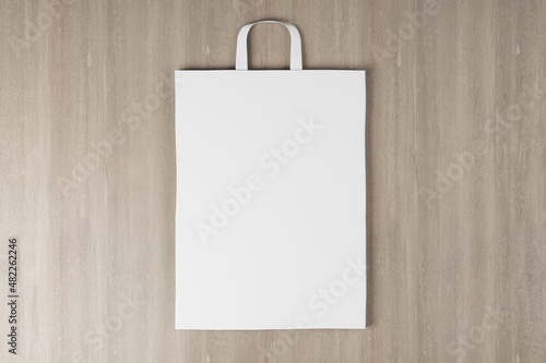 Close up of empty white paper bag on wooden background. Mock up place for your advertisement or logo. 3D Rendering.