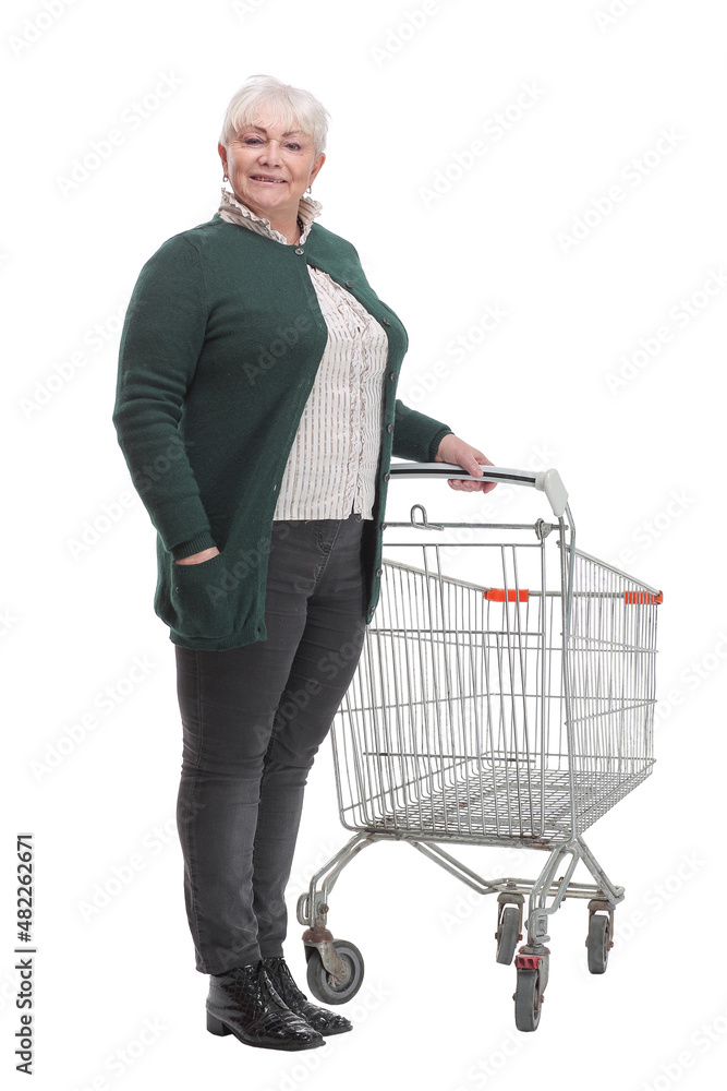 Full length profile shot of an elderly woman standing with an empty shopping cart Full length profile shot of an elderly woman standing with an empty shopping cart