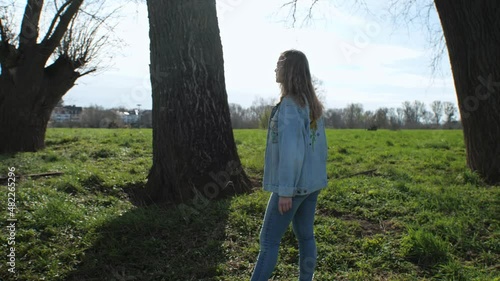 [4k] blonde girl casualy standing next to giant trees
