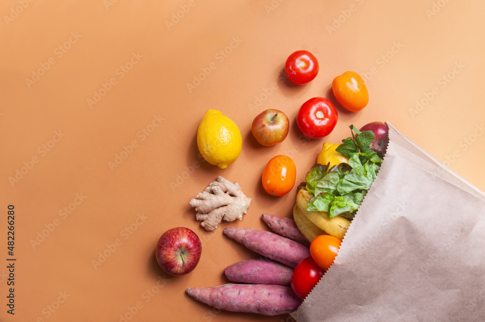Fruits and vegetables on the table in a bag grocery shopping food deliver sustainaility concept Fruits and vegetables on the table in a bag grocery shopping food deliver sustainaility concept