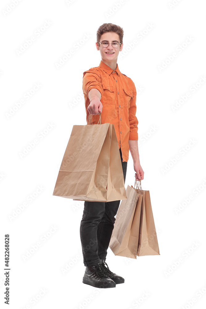 Front view of young man shopping in the mall with many shopping bags in his hand Front view of young man shopping in the mall with many shopping bags in his hand