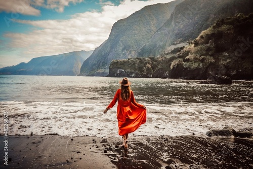 woman in dress on the beach from seixal madeira portugal 