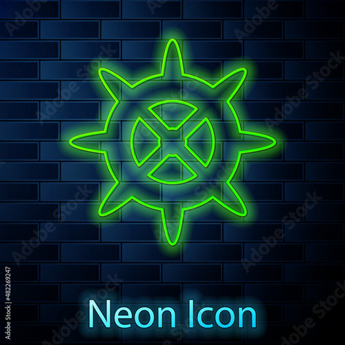 Glowing neon line Bicycle sprocket crank icon isolated on brick wall background. Vector