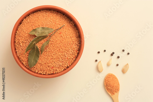 Making of Turkish traditional tarhana soup. Tomato paste, onion, garlic, parsley, salt, black pepper, olive oil. Overhead shot.