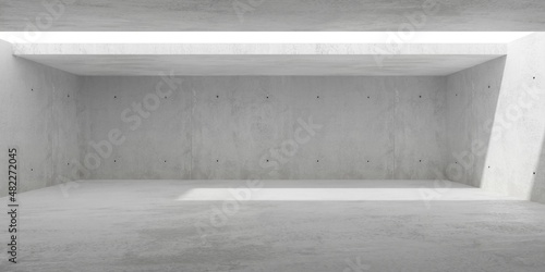 Empty modern abstract concrete room with light thru rectangular ceiling opening in the center and rough floor - industrial interior background template