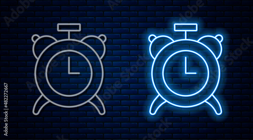 Glowing neon line Alarm clock icon isolated on brick wall background. Wake up, get up concept. Time sign. Vector
