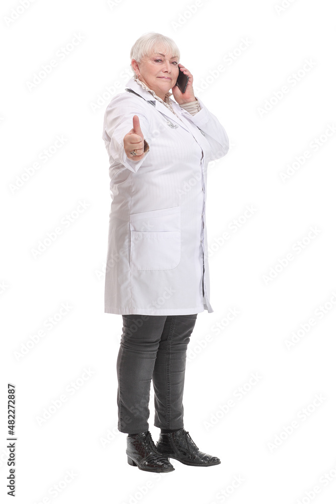 Portrait of middle aged female doctor talking with somebody on her mobile phone. Portrait of middle aged female doctor talking with somebody on her mobile phone.