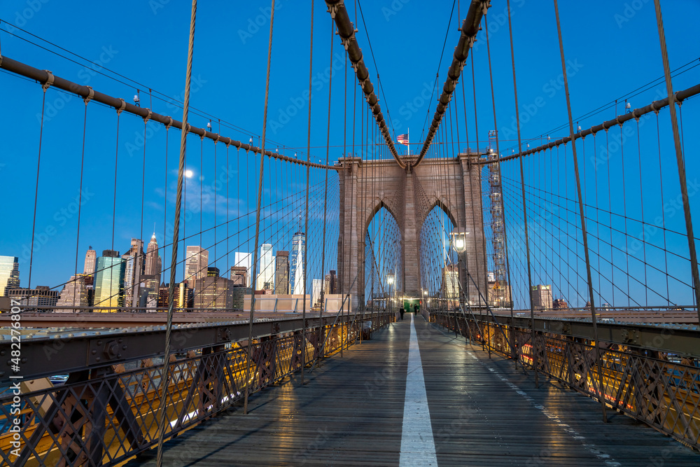 Fototapeta premium Night Picture of the Brooklyn Bridge With Full Moon over Manhattan in the background