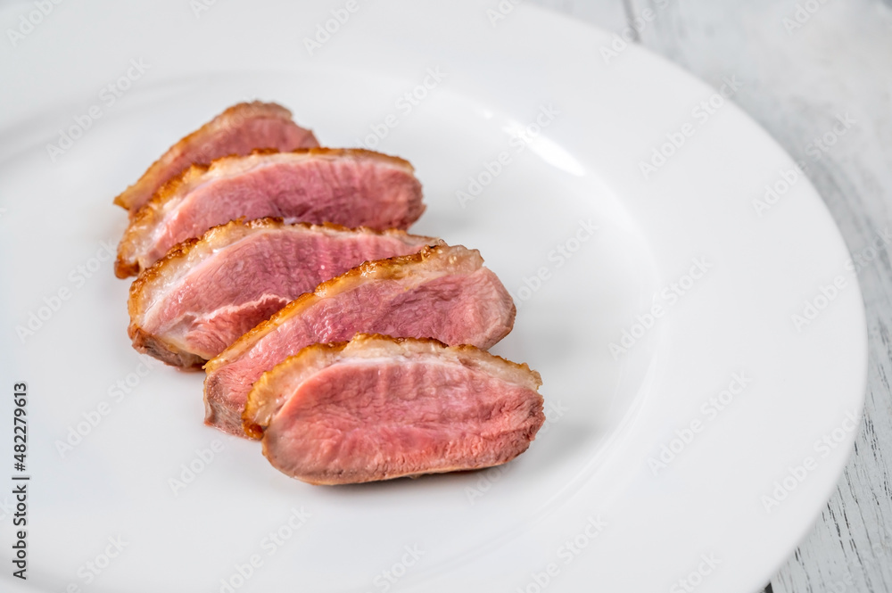 Sliced fried duck breast on the plate