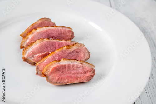 Sliced fried duck breast on the plate